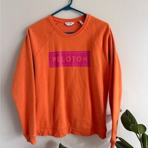 Peloton woman’s Vibrant Orange Crewneck Sweatshirt.